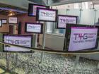 Creative display of computer monitors showing T4G logo. Credit Alex Irwin.